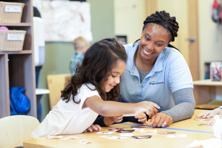 Movida Heights teacher guiding a student through a learning activity